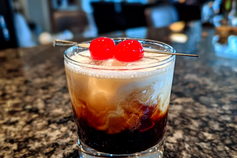 Vibrant display of ingredients for Winter Wonderland Kahlua Cocktail including Kahlua, Irish cream, and fresh milk.